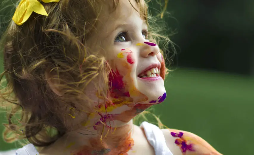 Little girl with paint